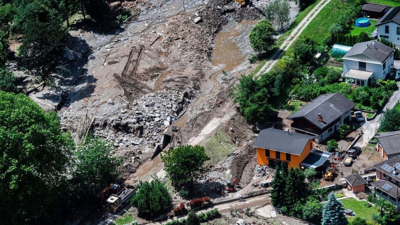 A rescue operation has been launched in Switzerland to find three people missing after a landslide caused by exceptionally rare rainfall